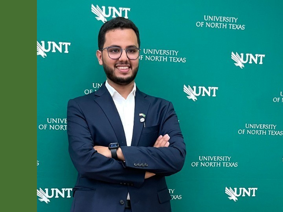 Photo of Ziyad in front of UNT banner